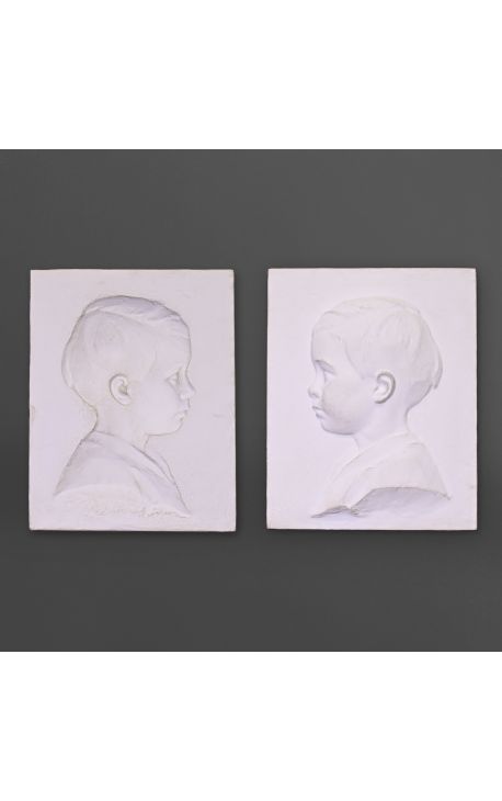 Pair of plaster child profile to be attached to the wall - negative and positive