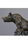 Bronze sculpture of a rhinoceros on a black marble base