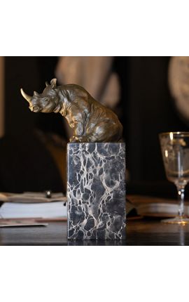 Bronze sculpture of a rhinoceros on a black marble base