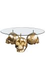 Round coffee table with golden death head and glass top